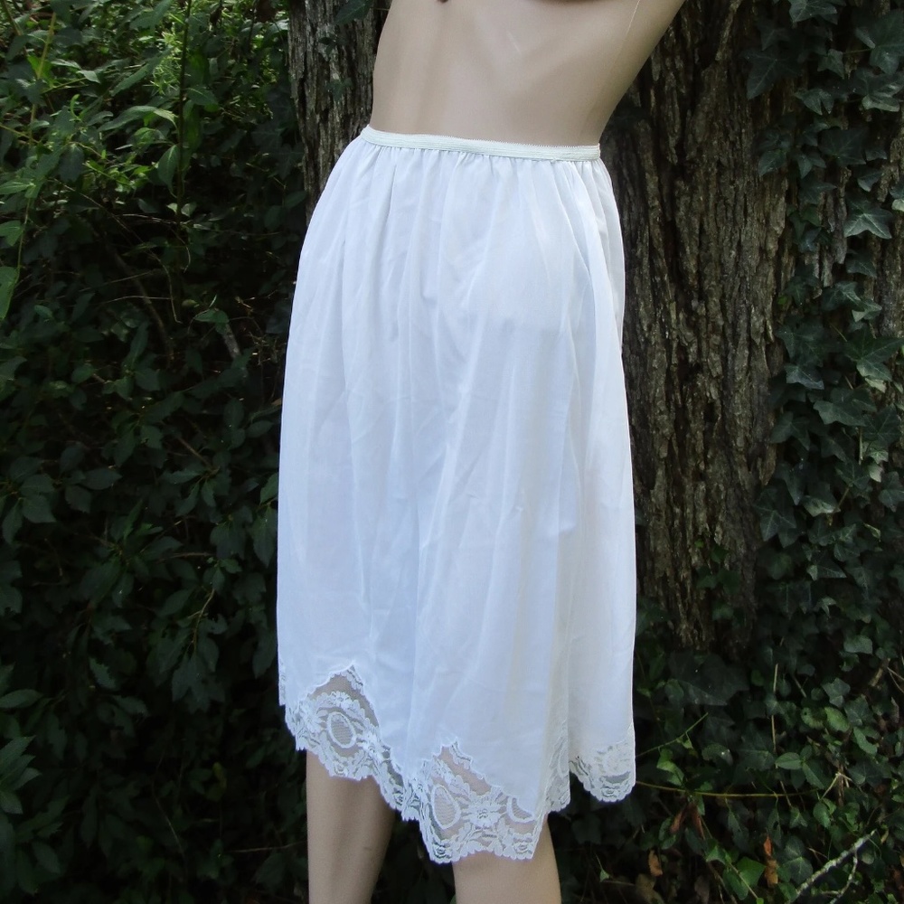 never worn white vintage nylon half slip with original tag and deep lace detail